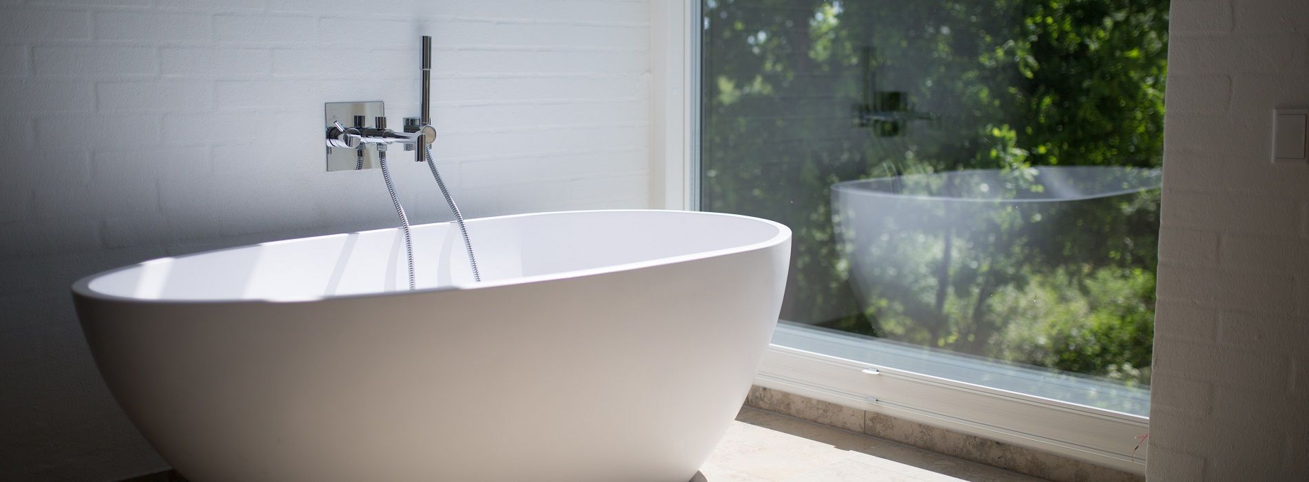 Bath beside large window